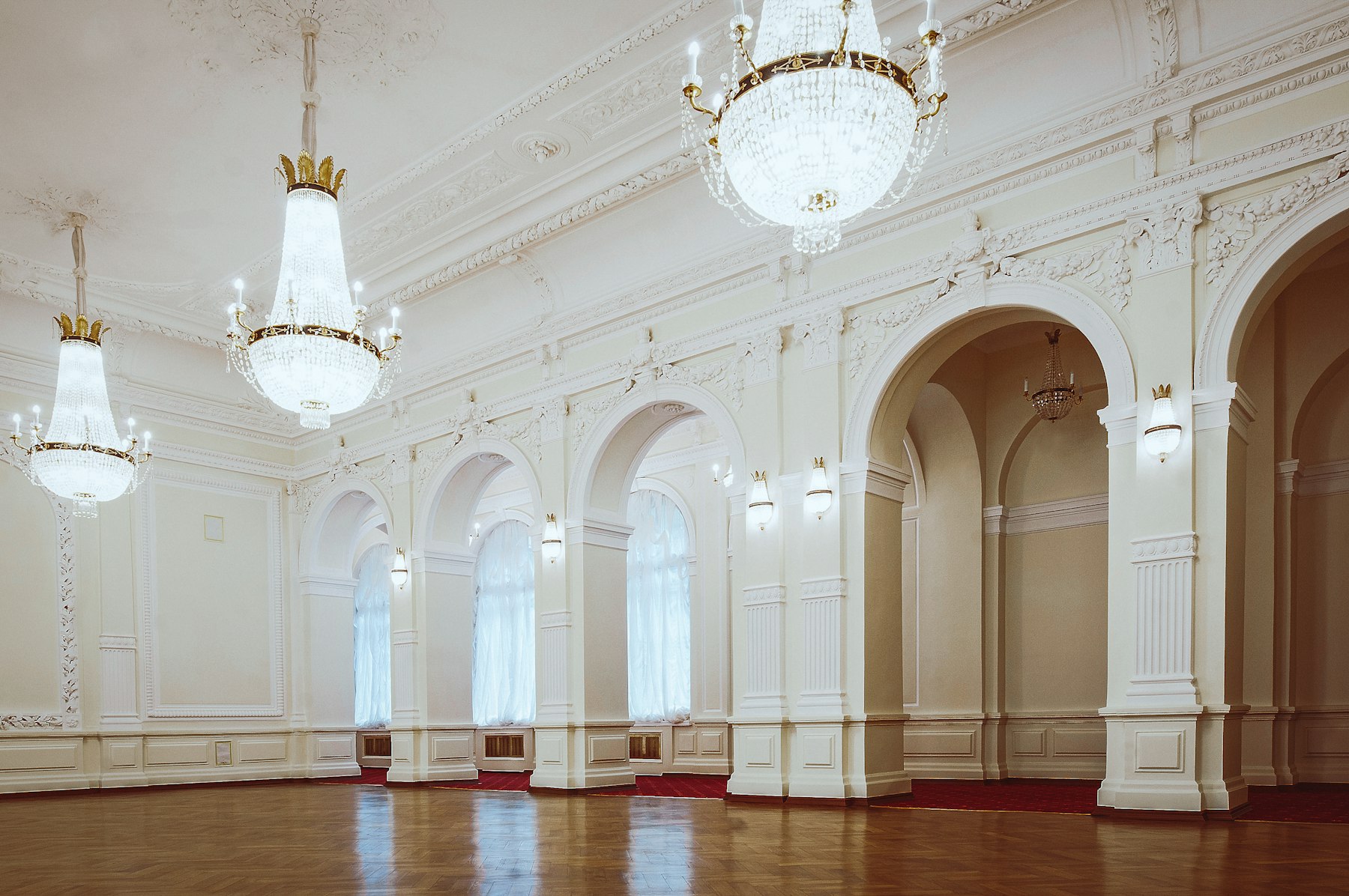 Empty ballroom with crystal chandeliers